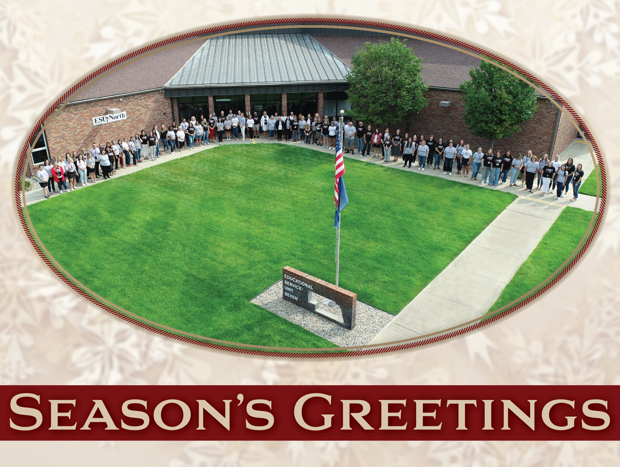Drone image showing ESU 7 staff lined up on the sidewalk in front of the North ESU 7 