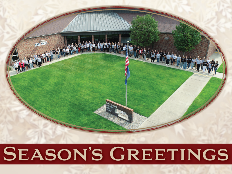 Drone image showing ESU 7 staff lined up on the sidewalk in front of the North ESU 7 