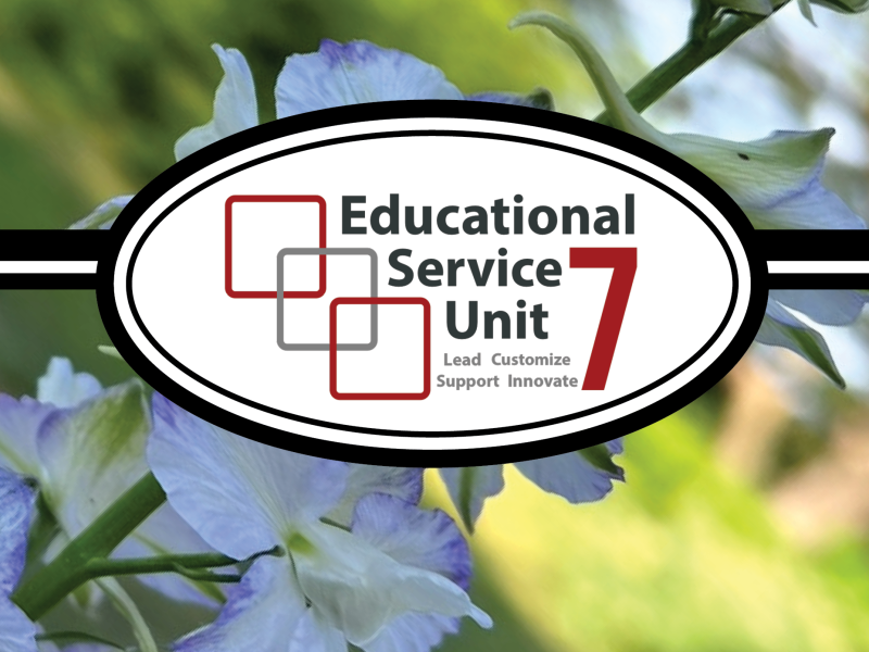 Decorative image with Educational Service Unit 7 logo centered over a soft-focus background of purple and white flowers.