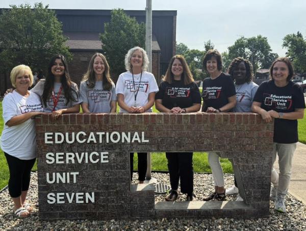 Photo of Cen7ter staff standing by ESU 7 sign